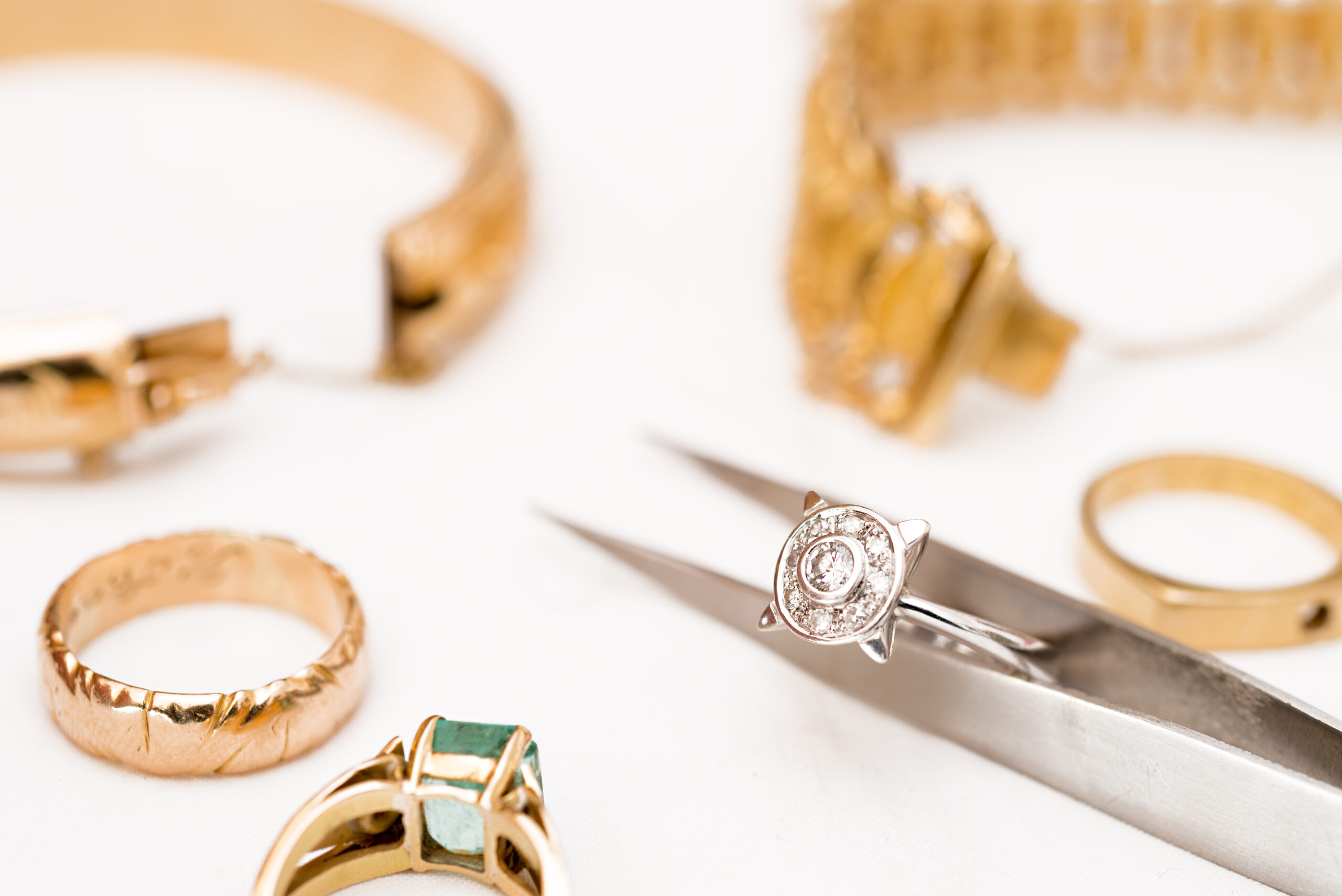 gold-and-diamond-jewelry-assortment-examined-by-jeweler