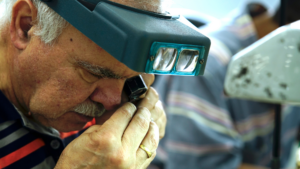 jeweler-examining-ring-through-lens