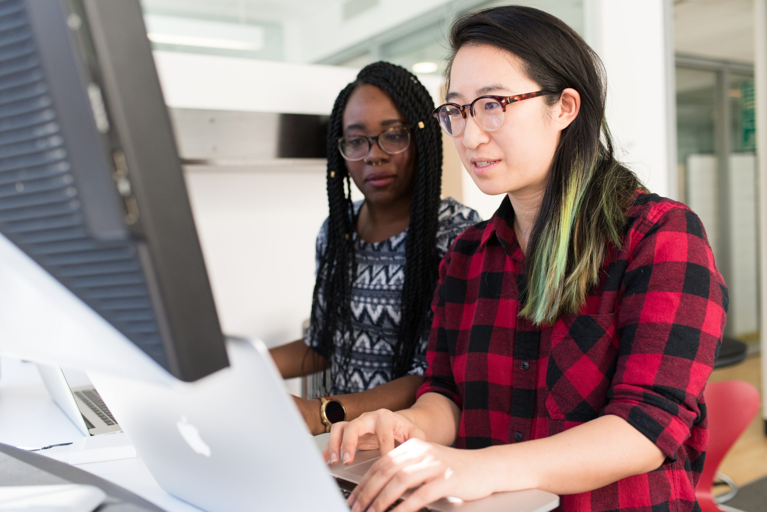 two-team-members-working-at-computer-using-software