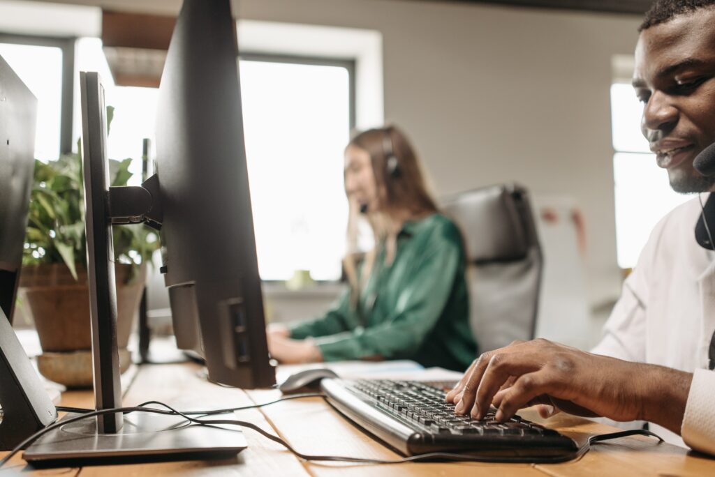 two-employees-working-on-computers-customer-service